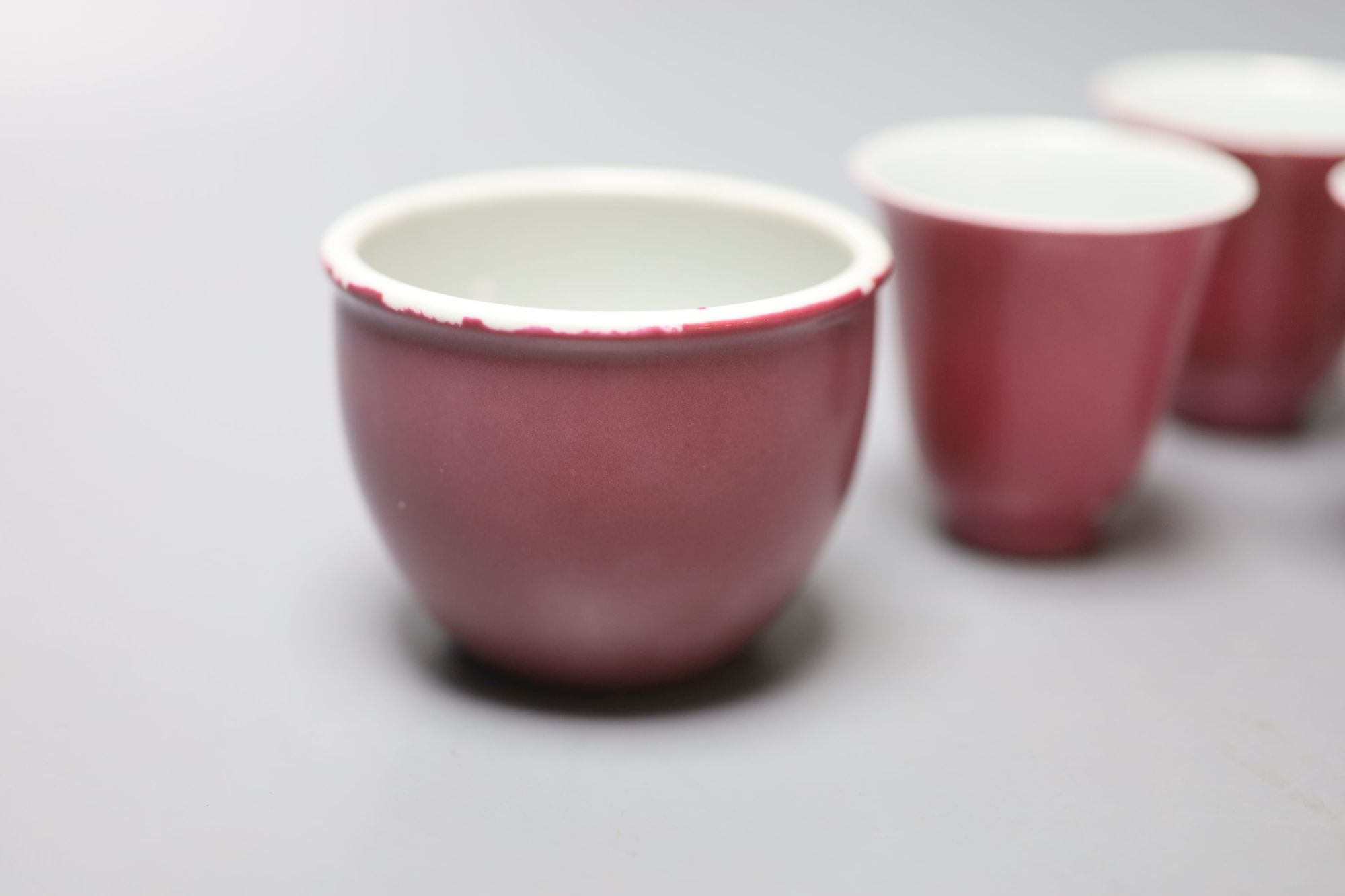 Four Chinese ruby ground cups, and a similar pair of cups, height 6cm